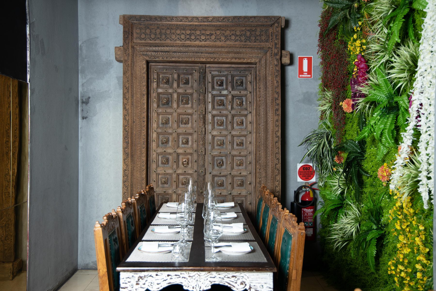 Private dining beneath hand-carved antique doors in The Grand Palace's basement dining room